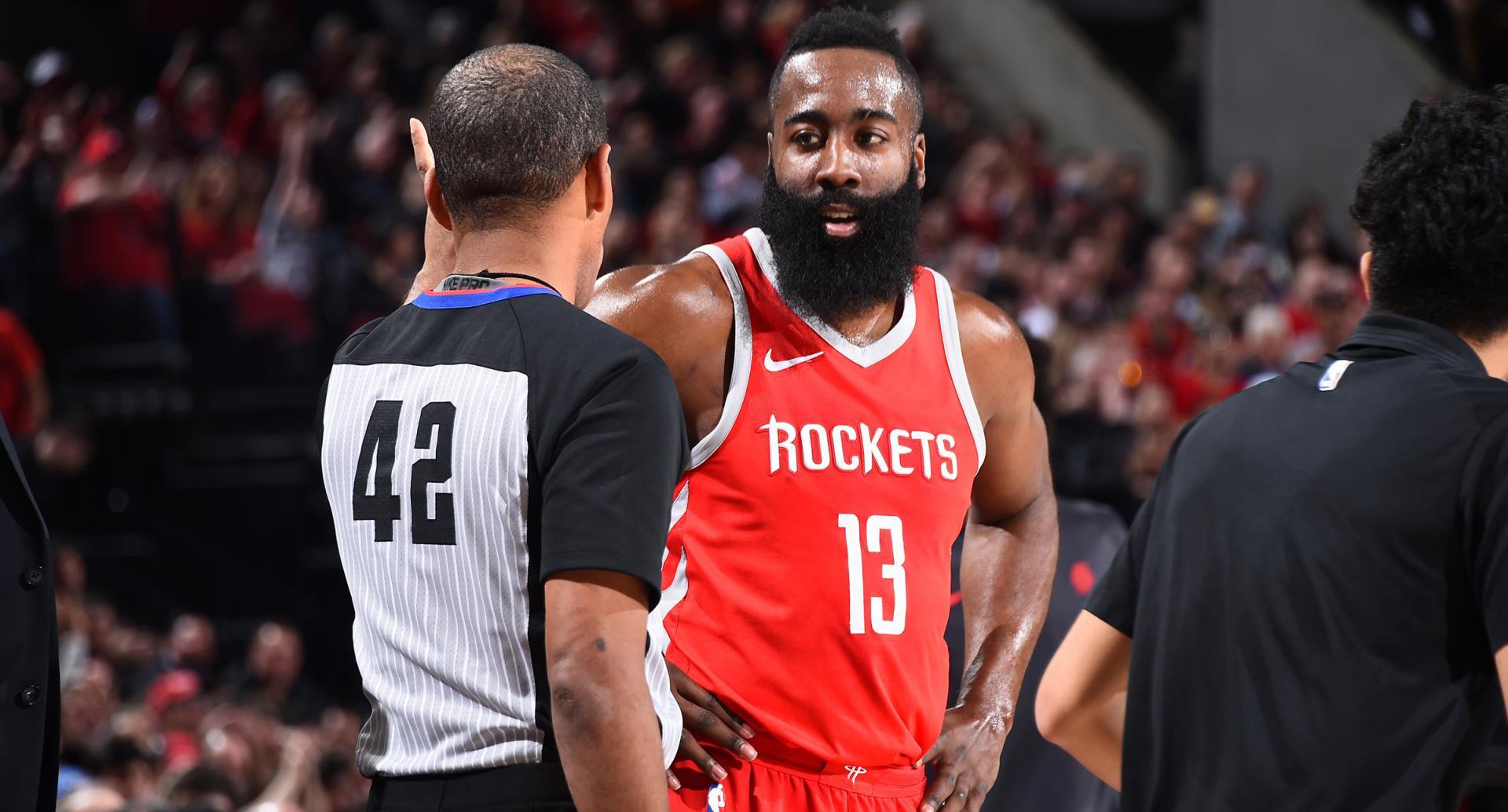 James Harden in a Houston Rockets jersey talking with a referee.